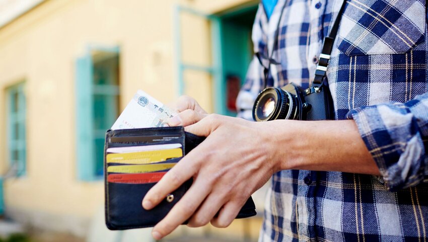 A man opening his wallet.