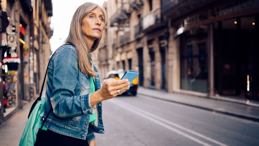 An older woman looking at her phone.