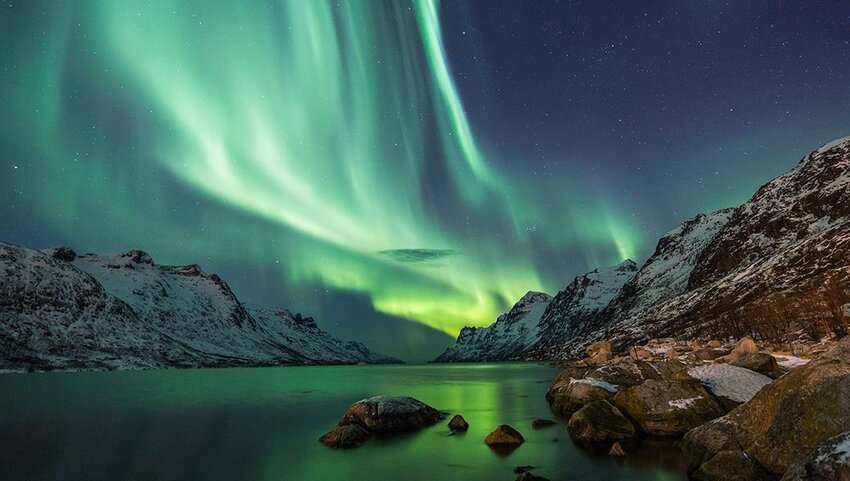 Northern Lights above waters edge in Lapland, Finland. 