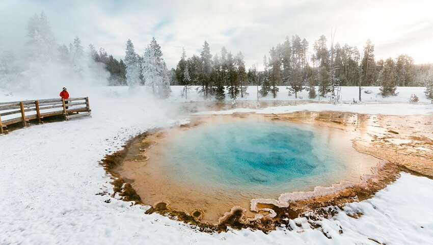 Women next to a hot spring in winter at Yellowstone National Park. 