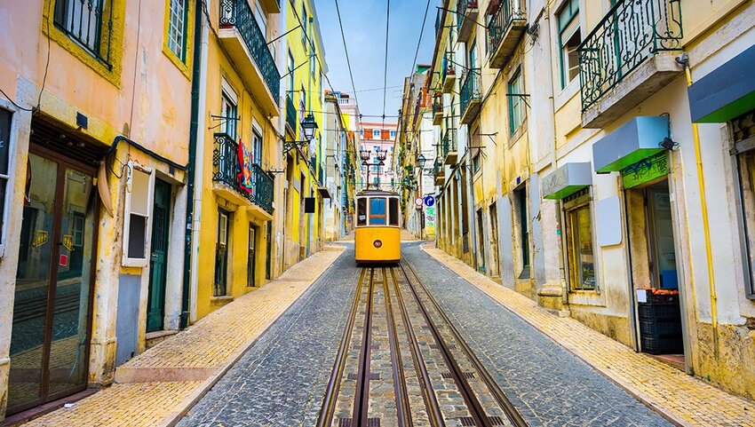 Lisbon, Portugal old town streets and tram.