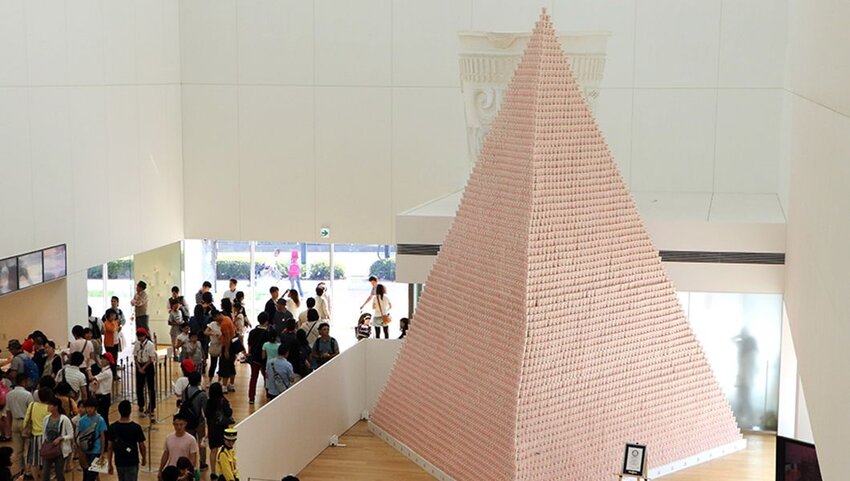 People look at a display of instant noodles pyramid.