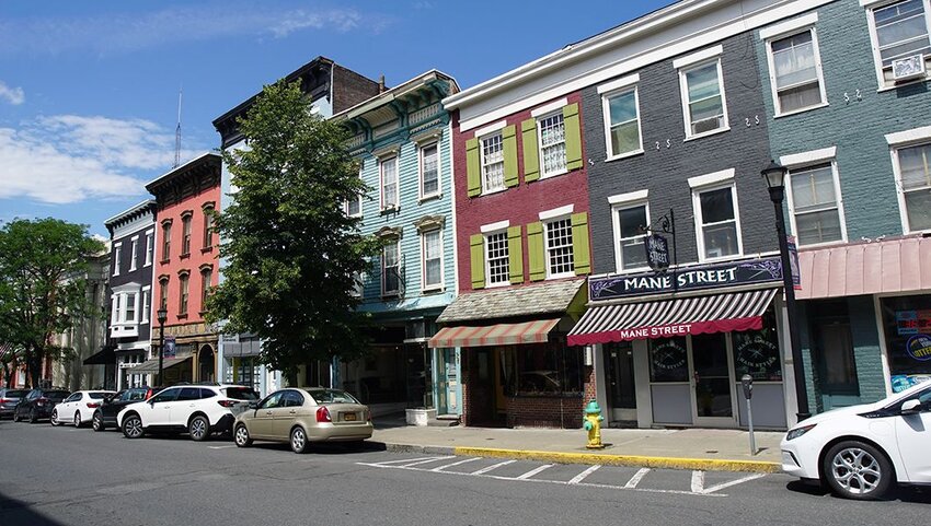 Cars parked on street and shops in Hudson, New York.