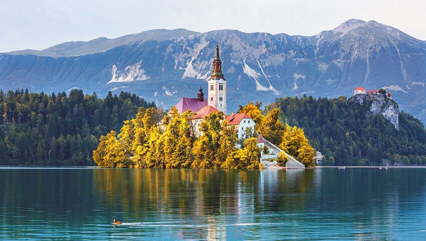 Sunrise view On Bled Lake, Island,Church And Castle With Mountain Range.