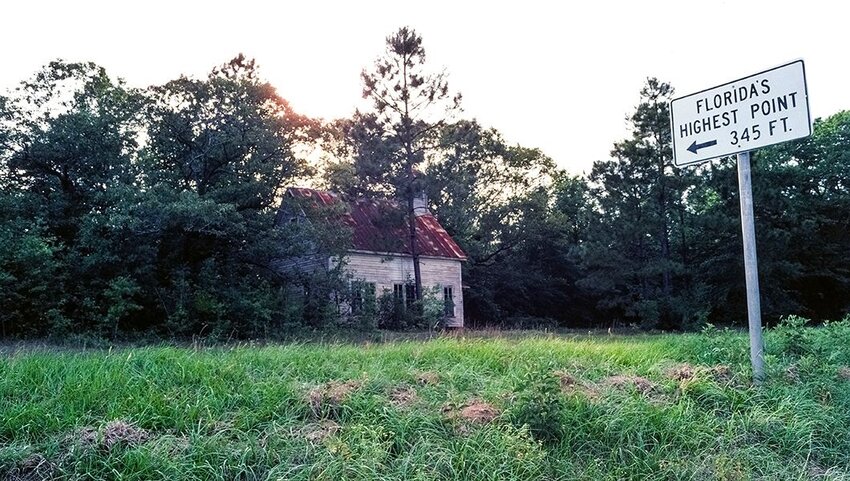 Old house and sign pointing to the highest natural point in the state of Florida