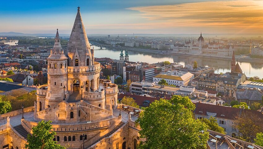 Sunrise with the tower of Fisherman's Bastion and Parliament of Hungary and River Danube in background. 