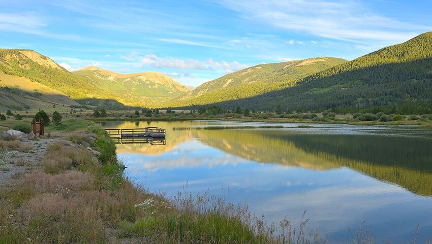A scenic autumn sunset at Camp Hale pond towards Sheep Mountain, north of Leadville CO.