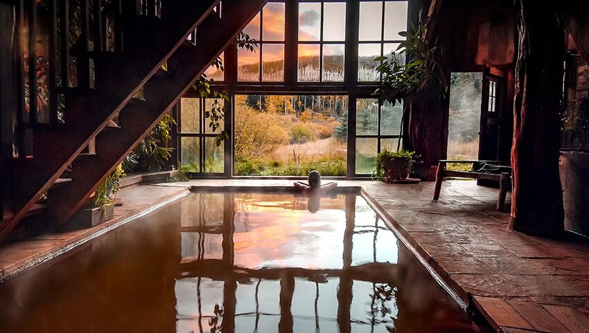 Person in steam pool inside a bathhouse at Dunton Hot Springs Resort.