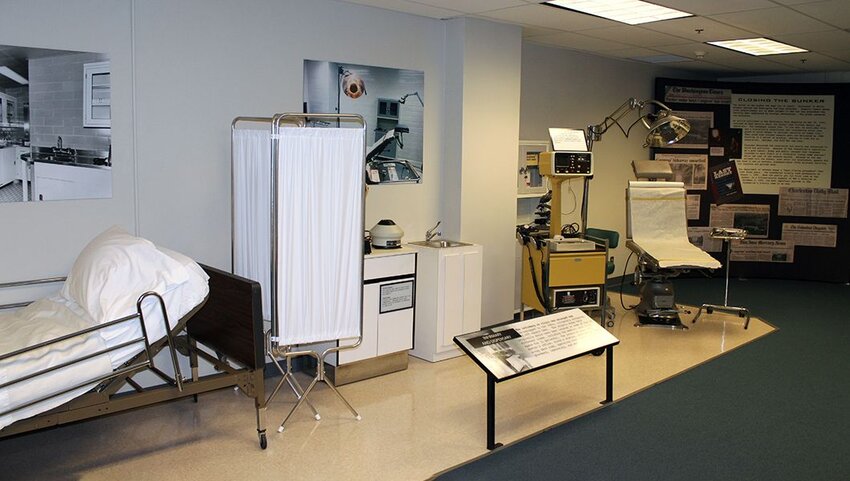 Hospital bed and dentist chair with other equipment on display in the Greenbrier bunker.