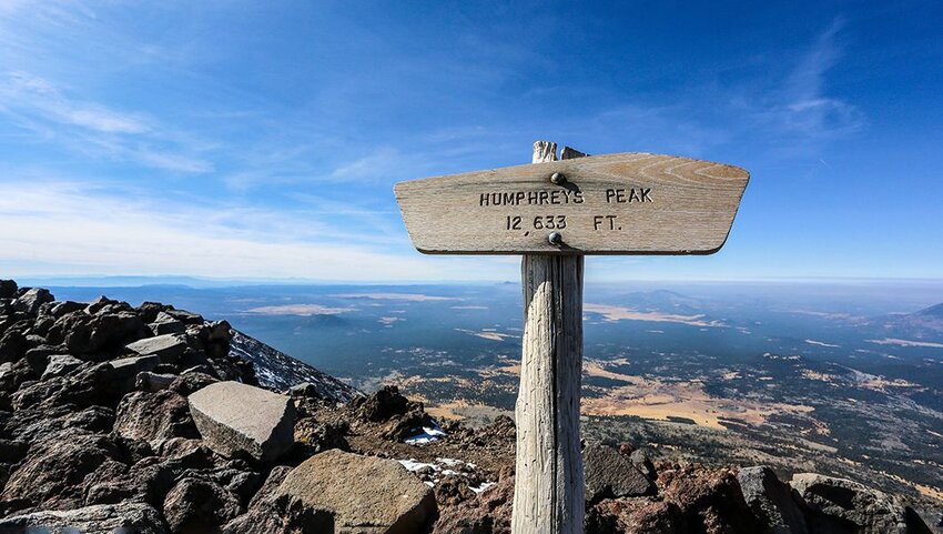 Sign at the top of Humphrey's Peak listing the name and height.