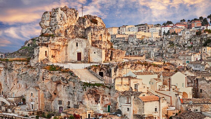  landscape at sunset of Sassi di Matera with the rock church Santa Maria de Idris.