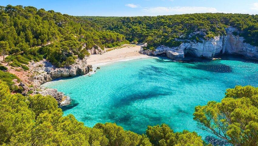 View of Mitjaneta beach with beautiful turquoise sea water, Menorca island, Spain.