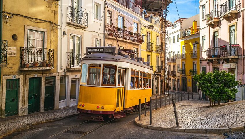 Tram going through streets in Lisbon. 