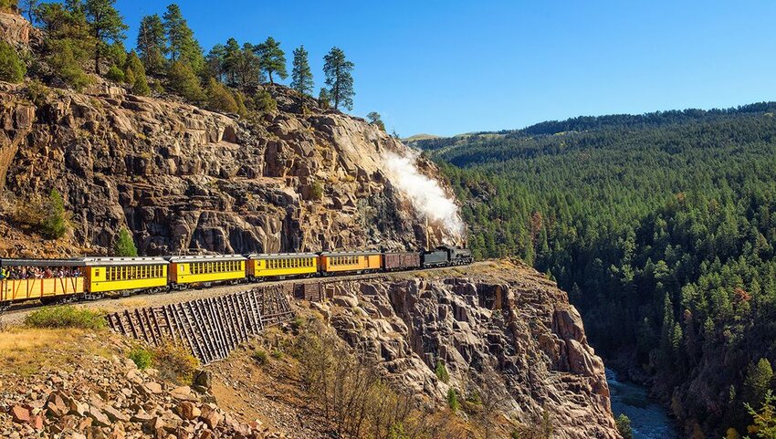 Historic steam engine train travels from Durango to Silverton through the San Juan Mountains in Colorado.