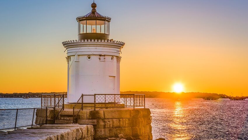 Sunset behind Portland Breakwater Light in Portland, Maine.