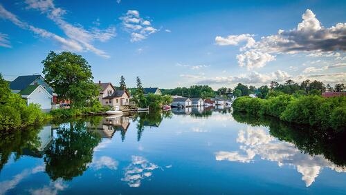 Houses and trees along the Winnipesaukee River, in Laconia, New Hampshire.