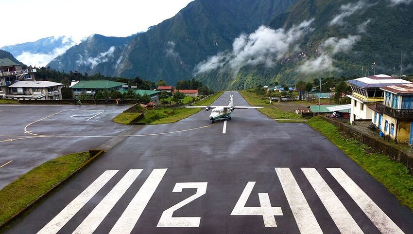 Small plane landing at the "Tenzing-Hillary" Airport in Lukla on a cloudy day.