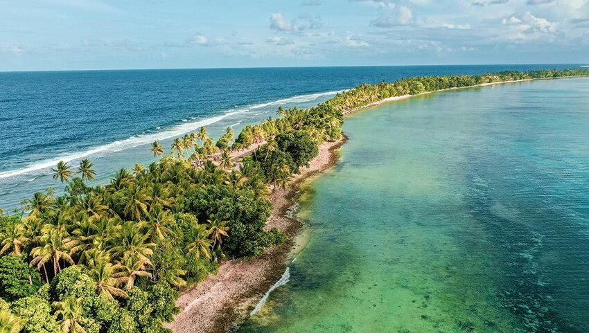 Aerial of Tuvalu showing the beach and palm trees. 