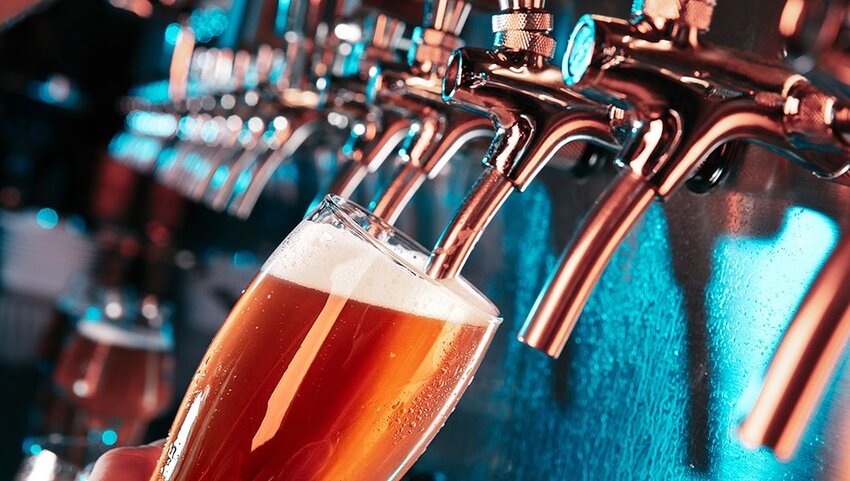 Beer glass being filled from tap.