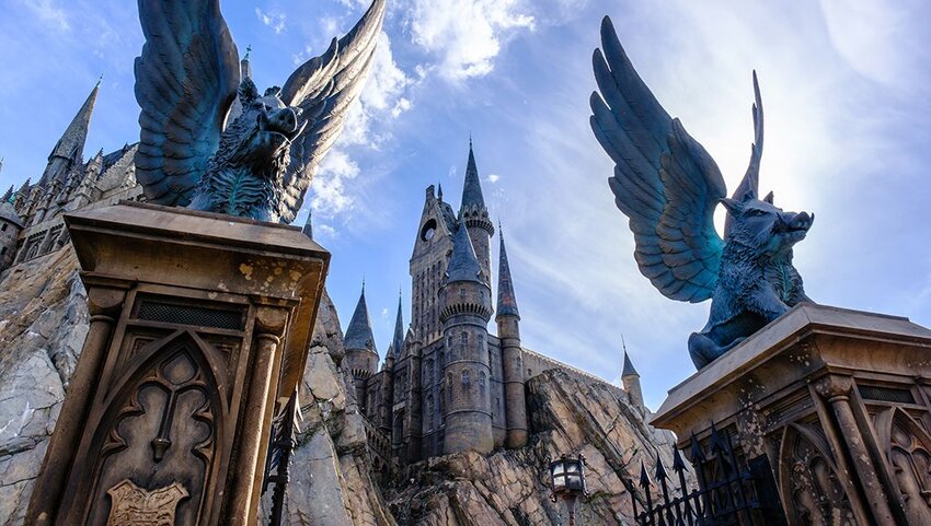 Winged boar statues on gate in front of Hogwarts castle at Universal Studios.