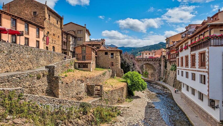  Views of the medieval village of Potes with hanging houses and Deva river.