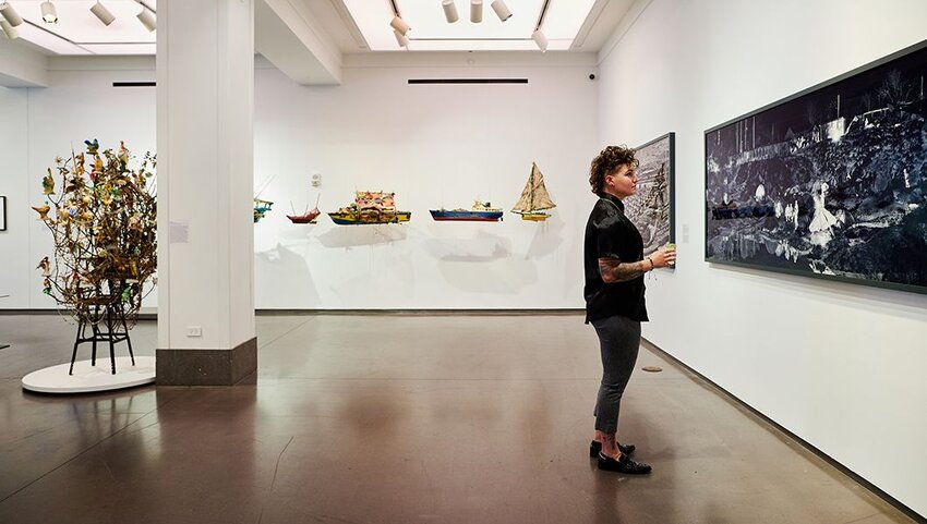 Woman looking at art in gallery at 21c Museum Hotel.