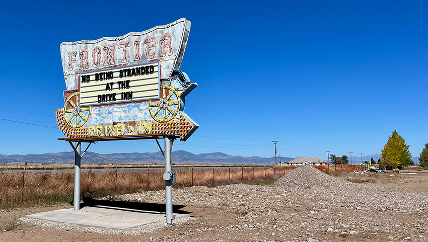 The original drive-in sign for the Frontier Drive-Inn shaped like a covered wagon.