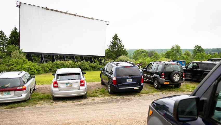 The Mahoning Drive-In Theater movie screen with cars parked in front.