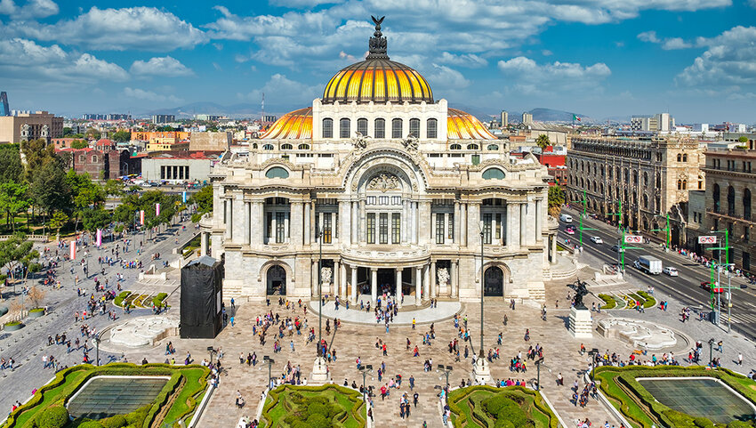 Aerial of Palacio de Bellas Artes in Mexico City with people walking all around.