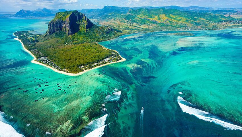 Aerial of Mauritius island, Le Morne Brabant mountain, blue lagoon and underwater waterfall