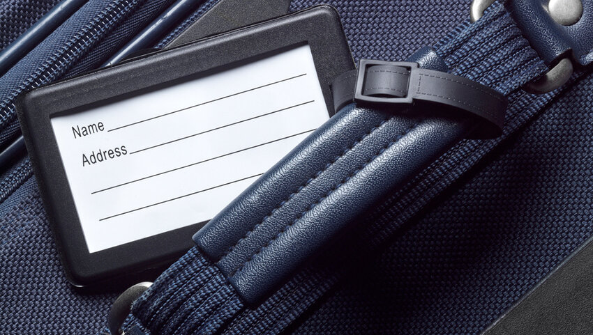 Close up of luggage tag on suitcase.