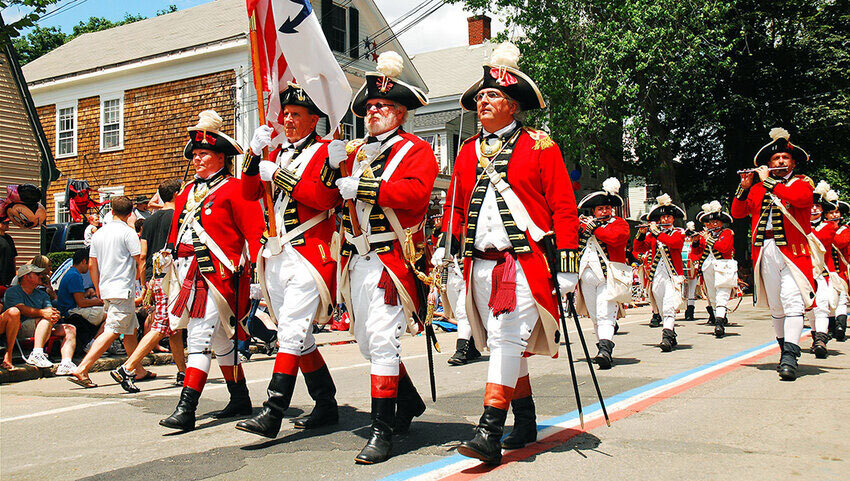A troop of redcoats march in a Fourth of July Parade in Bristol, Rhode Island.