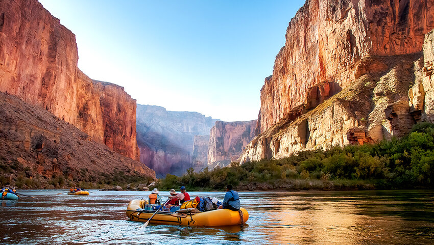 Rafting on The Colorado River in the Gran Canyon at sunrise.