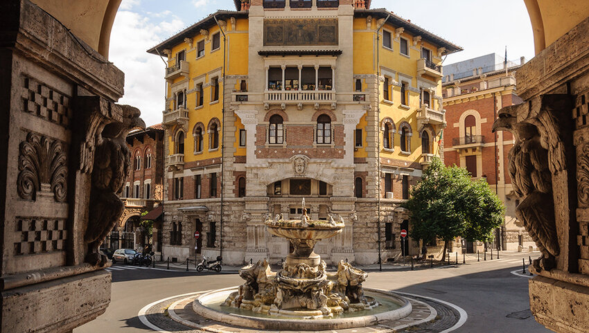 Fountain surrounded by buildings in Quartiere Coppedè.