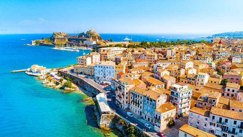 Panoramic view of buildings of Kerkyra, Corfu on coast.