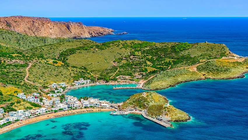 Aerial view of Kythira with bay of water, harbor, beach, mountains and green nature.