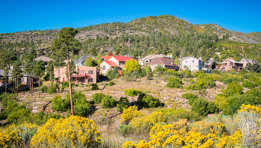 Large house with mountains behind them.