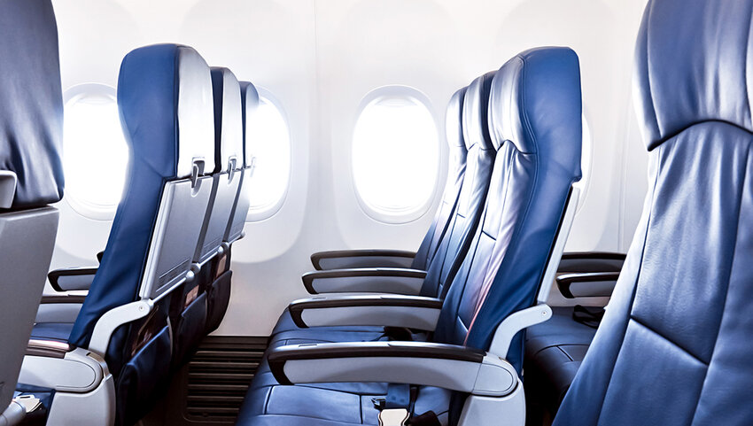 Empty airplane seats in the cabin.