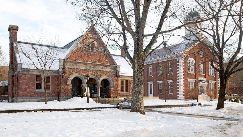 The Norman Williams Public Library and Windsor County Courthouse in Woodstock, Vermont with snow on the ground.