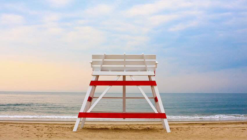 Lifeguard stand facing ocean on beach.