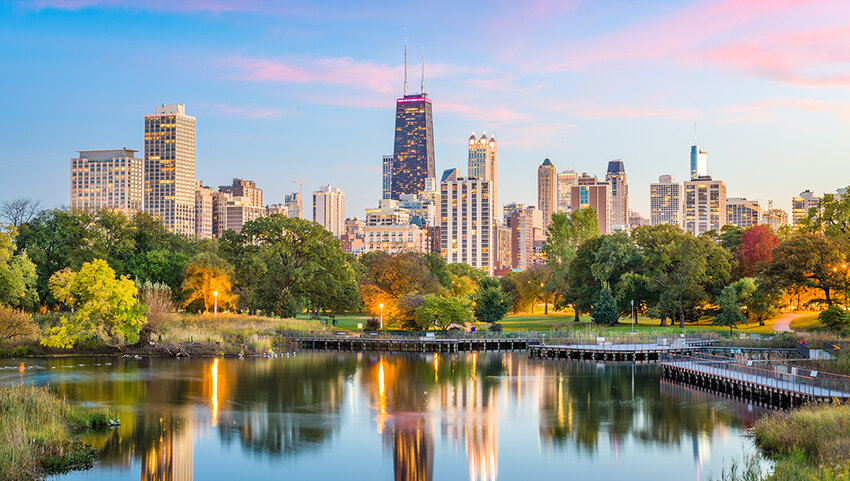 Downtown Chicago skyline seen from park, with pond in foreground. 