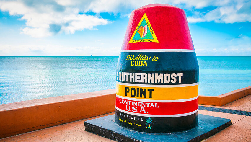 Empty scenic view of the colorful concrete buoy featuring the municipal seal of Key West marking the southernmost point of the continental USA .