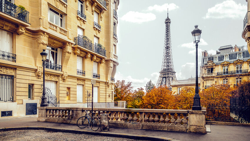 End of a street in Paris with the Eiffel Tower in distance during fall.