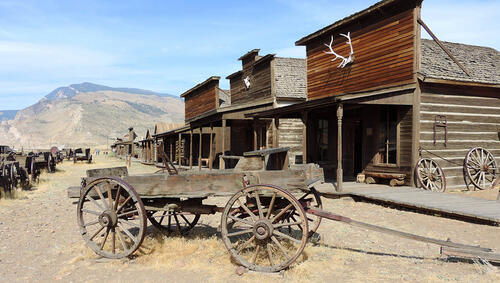Wagons in front of old west buildings. 
