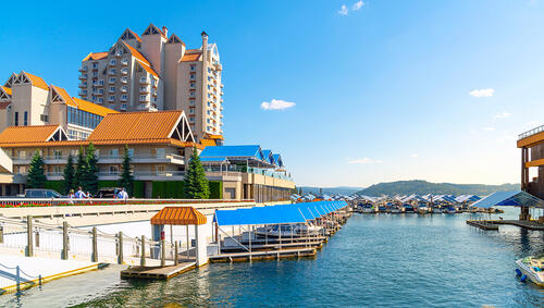 Summer view of the downtown marina with resort buildings and offices along lake.