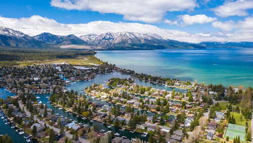 Aerial of South Lake Tahoe community with mountains in distance.