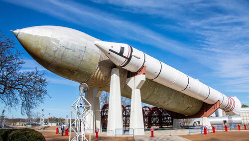  Space Shuttle external tank and Space Shuttle Solid Rocket Booster on display outdoors. 