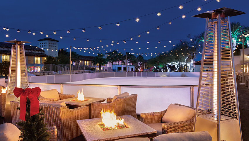 Chairs with fire pits next to ice skating rink.