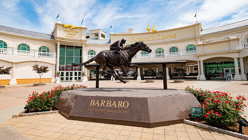 Entrance to Churchill Downs with statue of a horse and jockey.