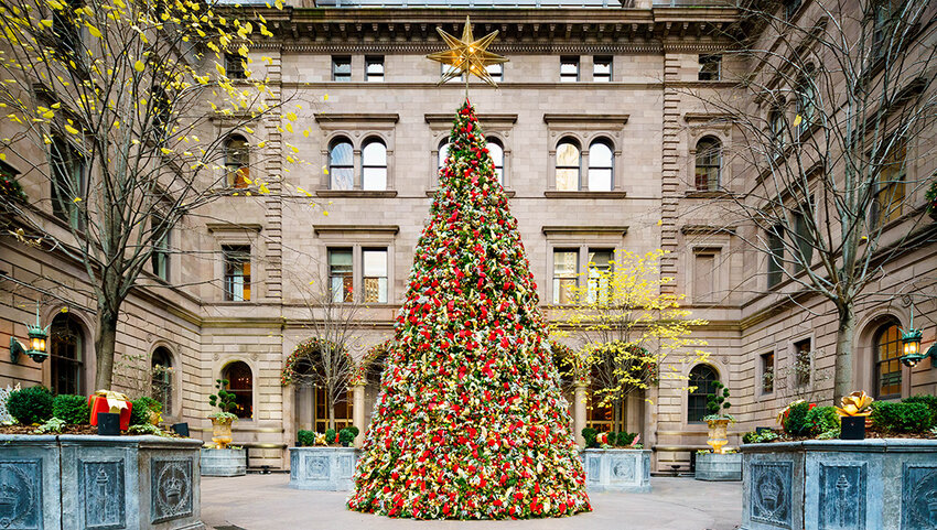 Courtyard of The Lotte New York Palace with decorated Christmas tree.